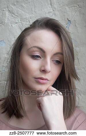 Stock Photo - Pensive young woman looking away.. Fotosearch