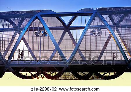 People passing by the Arganzuela bridge, designed by architect Dominique Perrault. Madrid Rio Park. Madrid. Spain. View Large Photo Image Stock Image - People passing by the Arganzuela bridge, designed by architect Dominique Perrault. Madrid Rio Park. Madrid. Spain.. Fotosearch