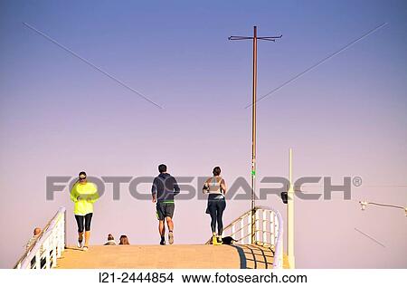 People running down a bridge, doing outdoor sports. Barcelona, Catalonia, Spain. View Large Photo Image Picture - People running down a bridge, doing outdoor sports. Barcelona, Catalonia, Spain.. Fotosearch