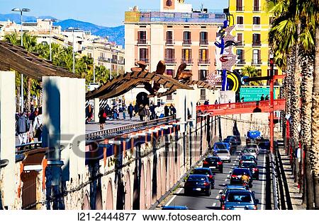 People walking down Moll de la Fusta. Traffic, car row at Ronda Litoral. Barcelona, Catalonia, Spain. View Large Photo Image Stock Photo - People walking down Moll de la Fusta. Traffic, car row at Ronda Litoral. Barcelona, Catalonia, Spain.. Fotosearch