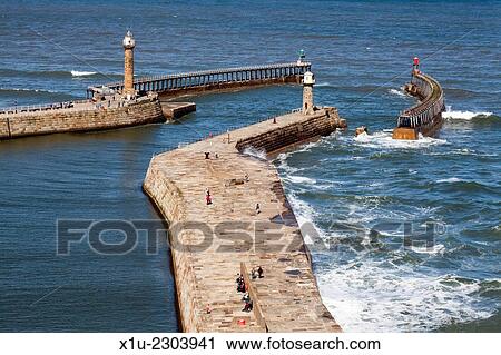 People Walking on the Piers at Whitby Yorkshire Coast England. View Large Photo Image Stock Image - People Walking on the Piers at Whitby Yorkshire Coast England.. Fotosearch
