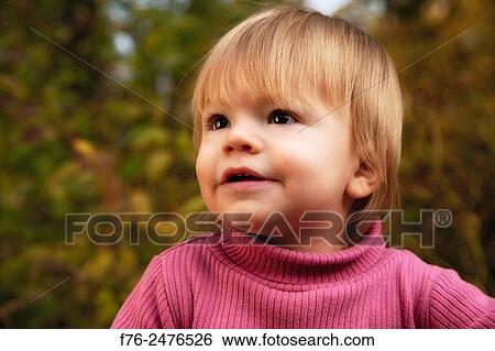 portrait of 1 year old girl looking up, with out of focus autumn leaves in background. View Large Photo Image Stock Photograph - portrait of 1 year old girl looking up, with out of focus autumn leaves in background.. Fotosearch