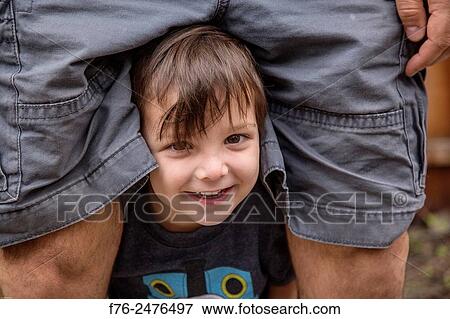 portrait of 3 year old boy poking his head out from between his father´s legs, mr# 6302. View Large Photo Image Stock Photo - portrait of 3 year old boy poking his head out from between his father´s legs, mr# 6302.. Fotosearch