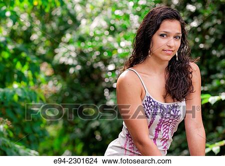 Portrait of a 19 year old brunette woman smiling at the camera. an. View Large Photo Image Picture - Portrait of a 19 year old brunette woman smiling at the camera. an.. Fotosearch