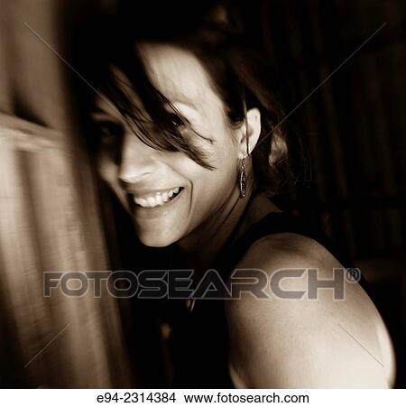 Portrait of a 30 year old brunette with hair partially covering her face, black & white. View Large Photo Image Picture - Portrait of a 30 year old brunette with hair partially covering her face, black & white.. Fotosearch