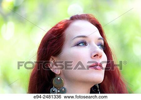 Portrait of a 37 year old redheaded woman looking way from the camera, outdoors. View Large Photo Image Stock Photograph - Portrait of a 37 year old redheaded woman looking way from the camera, outdoors.. Fotosearch