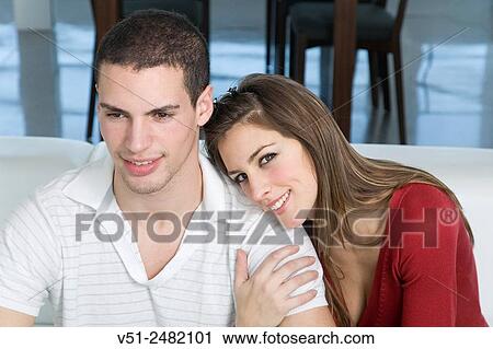 Stock Image - Portrait of a couple in sofa. Fotosearch