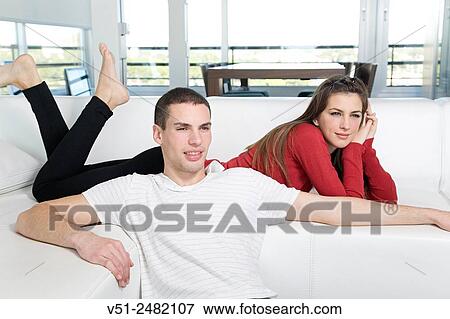 Stock Photo - Portrait of a couple in sofa. Fotosearch