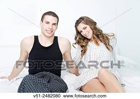Stock Image - Portrait of a happy couple in bed. Fotosearch