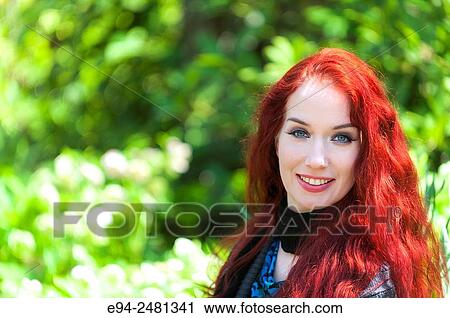Portrait of a smiling 37 year old redheaded woman with looking at the camera, outdoors. View Large Photo Image Stock Image - Portrait of a smiling 37 year old redheaded woman with looking at the camera, outdoors.. Fotosearch