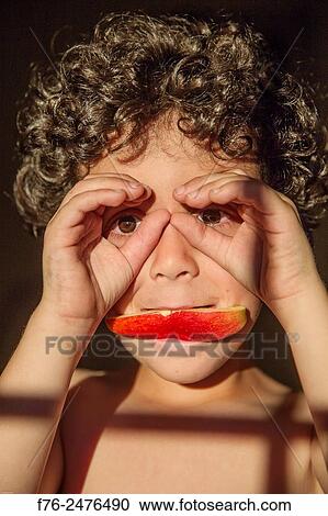 Portrait of a smiling 7 year old boy with an apple wedge in his mouth, mr# 6302. View Large Photo Image Stock Image - Portrait of a smiling 7 year old boy with an apple wedge in his mouth, mr# 6302.. Fotosearch