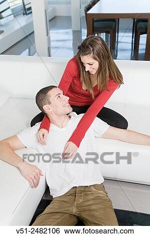 Portrait of a sweet couple in living room looking at each other View Large Photo Image Stock Photograph - Portrait of a sweet couple in living room looking at each other. Fotosearch