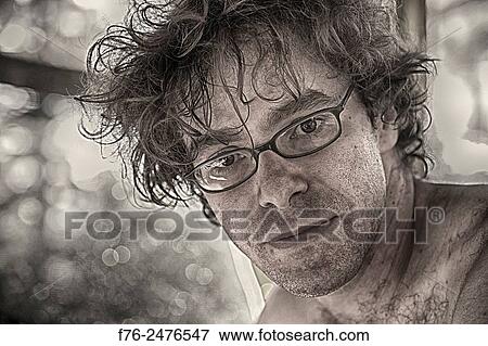portrait of man wearing glasses and in his early 30´s with most of the color removed. model released mr_6045. View Large Photo Image Stock Photo - portrait of man wearing glasses and in his early 30´s with most of the color removed. model released mr_6045.. Fotosearch