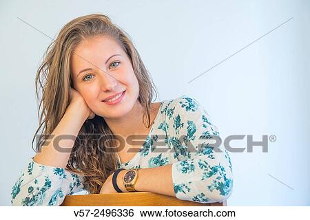 Portrait of pretty young woman smiling and looking at the camera. View Large Photo Image Stock Photograph - Portrait of pretty young woman smiling and looking at the camera.. Fotosearch