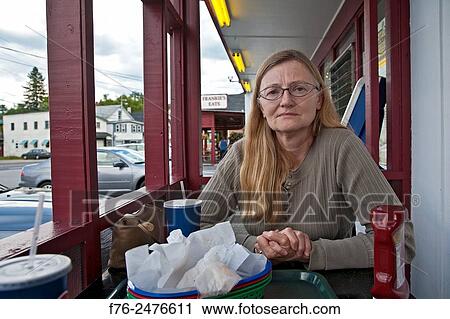 Stock Image - Portrait of serious woman at a fast food, greasy spoon, diner / restaurant in Whitefield, NH, mr# g060528_2.. Fotosearch