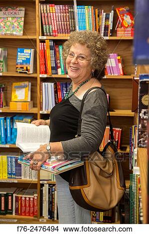 Portrait of well dressed woman in her 60s in a bookstore, buying children´s books for her grandchildren, MR# 4709. View Large Photo Image Picture - Portrait of well dressed woman in her 60s in a bookstore, buying children´s books for her grandchildren, MR# 4709.. Fotosearch