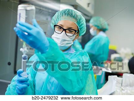 Stock Image - Preparation of drugs in laminar flow hood, epidural anesthesia, Clean room, Pharmacy, Hospital Donostia, San Sebastian, Gipuzkoa, Basque Country, Spain. Fotosearch