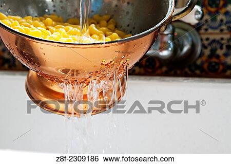 Quinoa gluten-free noodles are rinsed in a vintage colander after being fully cooked. View Large Photo Image Stock Photograph - Quinoa gluten-free noodles are rinsed in a vintage colander after being fully cooked.. Fotosearch