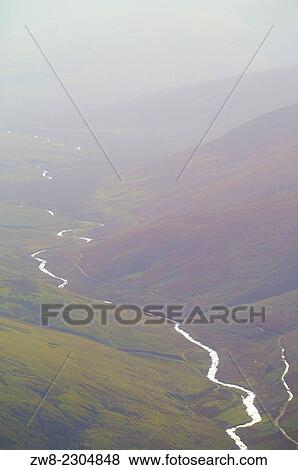 Stock Photo - River Caldew shining back of Skiddaw, Cumbria, England, UK.. Fotosearch