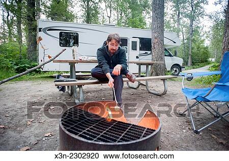 Roasting marshmallows at RV campsite. View Large Photo Image Stock Image - Roasting marshmallows at RV campsite.. Fotosearch
