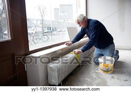 Rotterdam, Netherlands. Senior adult male cleaning the radiator in his store to be. View Large Photo Image Stock Photo - Rotterdam, Netherlands. Senior adult male cleaning the radiator in his store to be.. Fotosearch