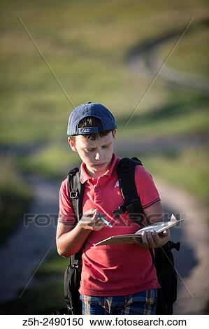 Stock Image - Russia. Belgorod region. Solomino village. The boy goes to the village school.. Fotosearch
