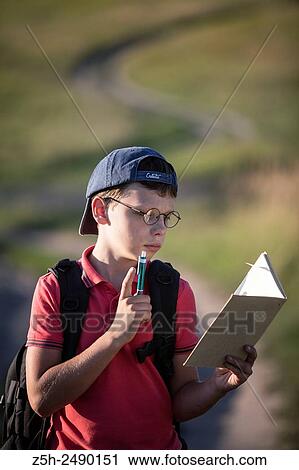 Stock Image - Russia. Belgorod region. Solomino village. The boy goes to the village school.. Fotosearch