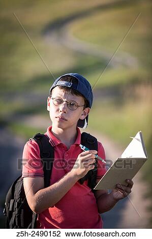 Stock Image - Russia. Belgorod region. Solomino village. The boy goes to the village school.. Fotosearch