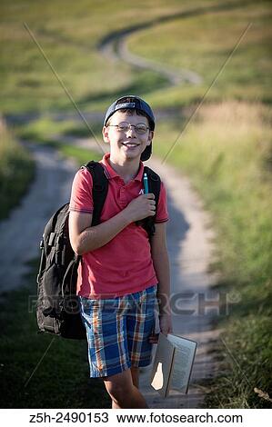 Stock Image - Russia. Belgorod region. Solomino village. The boy goes to the village school.. Fotosearch