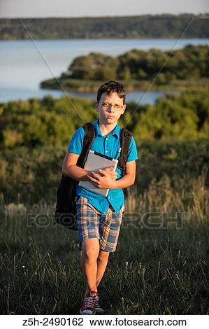 Stock Image - Russia. Belgorod region. Solomino village. The boy goes to the village school.. Fotosearch