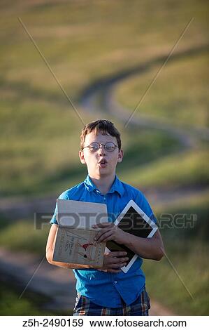 Russia. Belgorod region. Solomino village. The boy goes to the village school. View Large Photo Image Stock Photo - Russia. Belgorod region. Solomino village. The boy goes to the village school.. Fotosearch