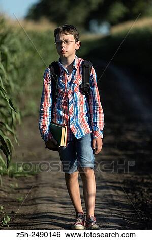 Russia. Belgorod region. Solomino village. The boy goes to the village school. View Large Photo Image Stock Photograph - Russia. Belgorod region. Solomino village. The boy goes to the village school.. Fotosearch