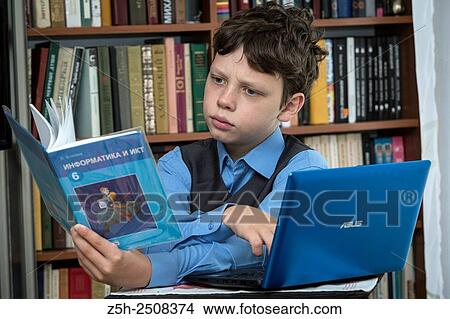 Picture - Russia. Belgorod region. Tavrovsky rural settlement. The village Solomino. Schoolboy doing homework.. Fotosearch