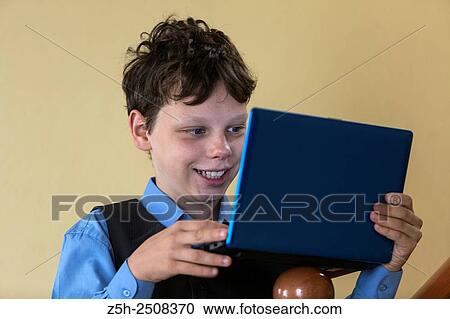 Stock Image - Russia. Belgorod region. Tavrovsky rural settlement. The village Solomino. Schoolboy doing homework.. Fotosearch