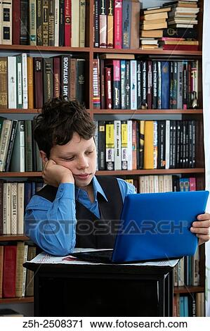 Stock Image - Russia. Belgorod region. Tavrovsky rural settlement. The village Solomino. Schoolboy doing homework.. Fotosearch