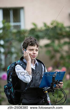 Stock Image - Russia. Belgorod region. Tavrovsky rural settlement. The village Solomino. Boy on bike rides to school.. Fotosearch