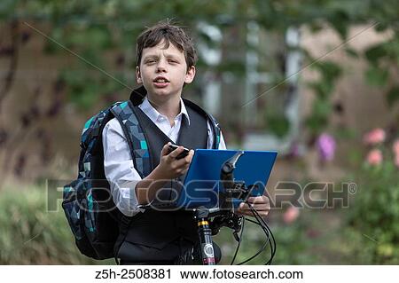 Stock Image - Russia. Belgorod region. Tavrovsky rural settlement. The village Solomino. Boy on bike rides to school.. Fotosearch