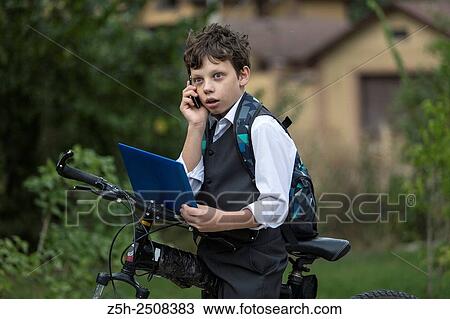 Stock Image - Russia. Belgorod region. Tavrovsky rural settlement. The village Solomino. Boy on bike rides to school.. Fotosearch