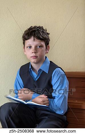 Stock Photo - Russia. Belgorod region. Tavrovsky rural settlement. The village Solomino. Schoolboy doing homework.. Fotosearch