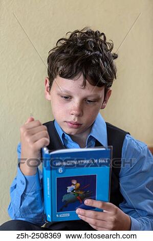 Stock Photo - Russia. Belgorod region. Tavrovsky rural settlement. The village Solomino. Schoolboy doing homework.. Fotosearch