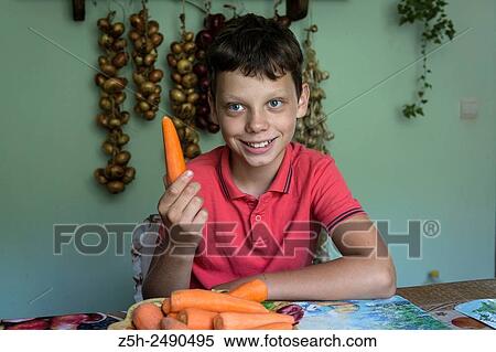 Russia. Boy cut raw vegetables on the kitchen table. View Large Photo Image Stock Photography - Russia. Boy cut raw vegetables on the kitchen table.. Fotosearch