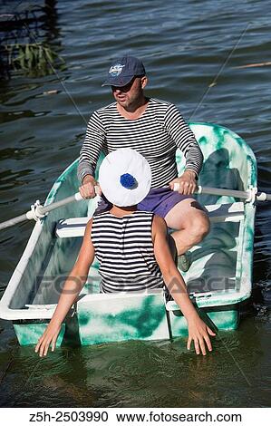 Stock Image - Russian Federation. Belgorod region. A man with a boy in a striped vest on boat trips.. Fotosearch