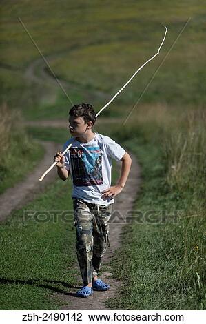 Russian Federation. Belgorod region. The boy goes on a fishing trip on the country road. View Large Photo Image Stock Image - Russian Federation. Belgorod region. The boy goes on a fishing trip on the country road.. Fotosearch