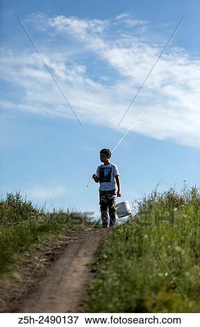 Russian Federation. Belgorod region. The boy goes on a fishing trip on the country road. View Large Photo Image Stock Photo - Russian Federation. Belgorod region. The boy goes on a fishing trip on the country road.. Fotosearch
