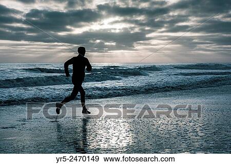 Saturday, 19th, April, 2014, The Headland, Hartlepool, England, United Kingdom. Jogger at sunrise on a frosty morning in north east England. View Large Photo Image Stock Photo - Saturday, 19th, April, 2014, The Headland, Hartlepool, England, United Kingdom. Jogger at sunrise on a frosty morning in north east England.. Fotosearch