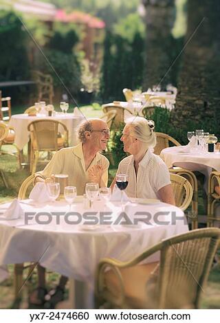 Stock Image - Senior couple at a restaurant.. Fotosearch