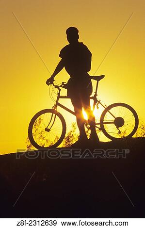 Silhouette of Male Biker at sunset. View Large Photo Image Stock Photo - Silhouette of Male Biker at sunset.. Fotosearch