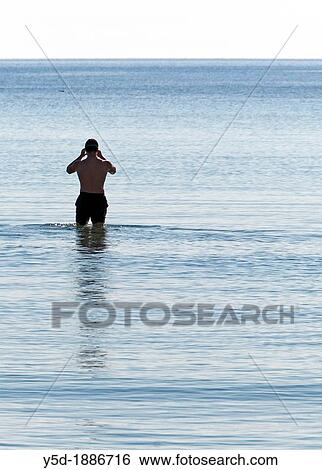 single man preparing for swimming in the sea, Mallorca, Balearic Islands, Spain, Europe View Large Photo Image Stock Photograph - single man preparing for swimming in the sea, Mallorca, Balearic Islands, Spain, Europe. Fotosearch