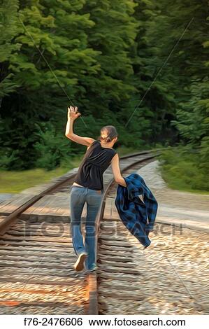 stylized image of girl in jeans balancing on / walking on railroad tracks in New Hampshire, mr_130807. View Large Photo Image Stock Photograph - stylized image of girl in jeans balancing on / walking on railroad tracks in New Hampshire, mr_130807.. Fotosearch