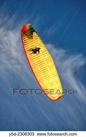 tandem paragliding flight seen from below. View Large Photo Image Stock Image - tandem paragliding flight seen from below.. Fotosearch